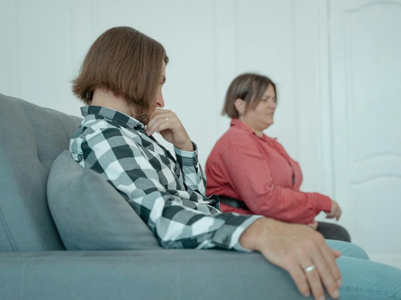 A person sitting calmly in a well-lit room, focused and serene.